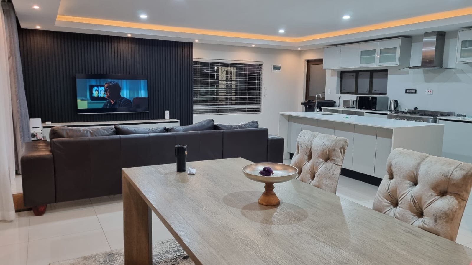 Open-plan living and dining area at The Pecan villa, Bulawayo